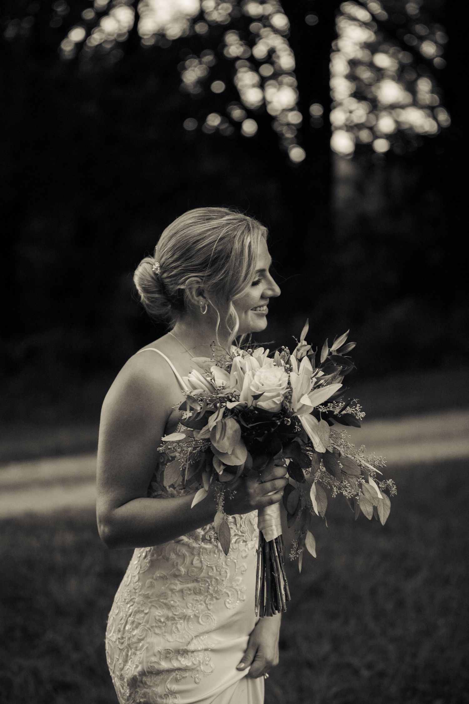 A solo portrait of a bride holding a bouquet of flowers in Holly, Michigan