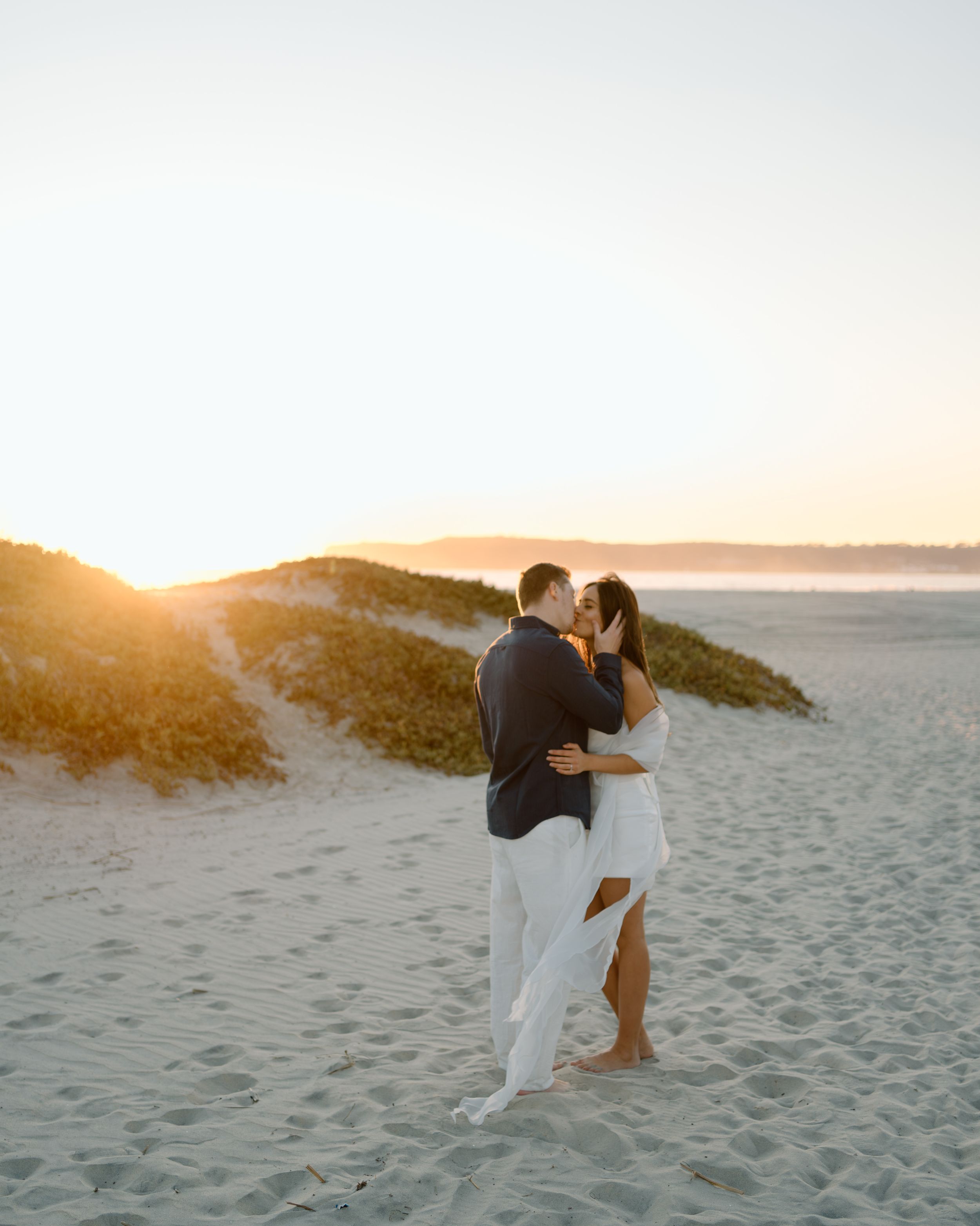 Dreamy oceanfront engagement session in San Diego. Sunset photography capturing the warmth, connection, and elegance of this romantic moment