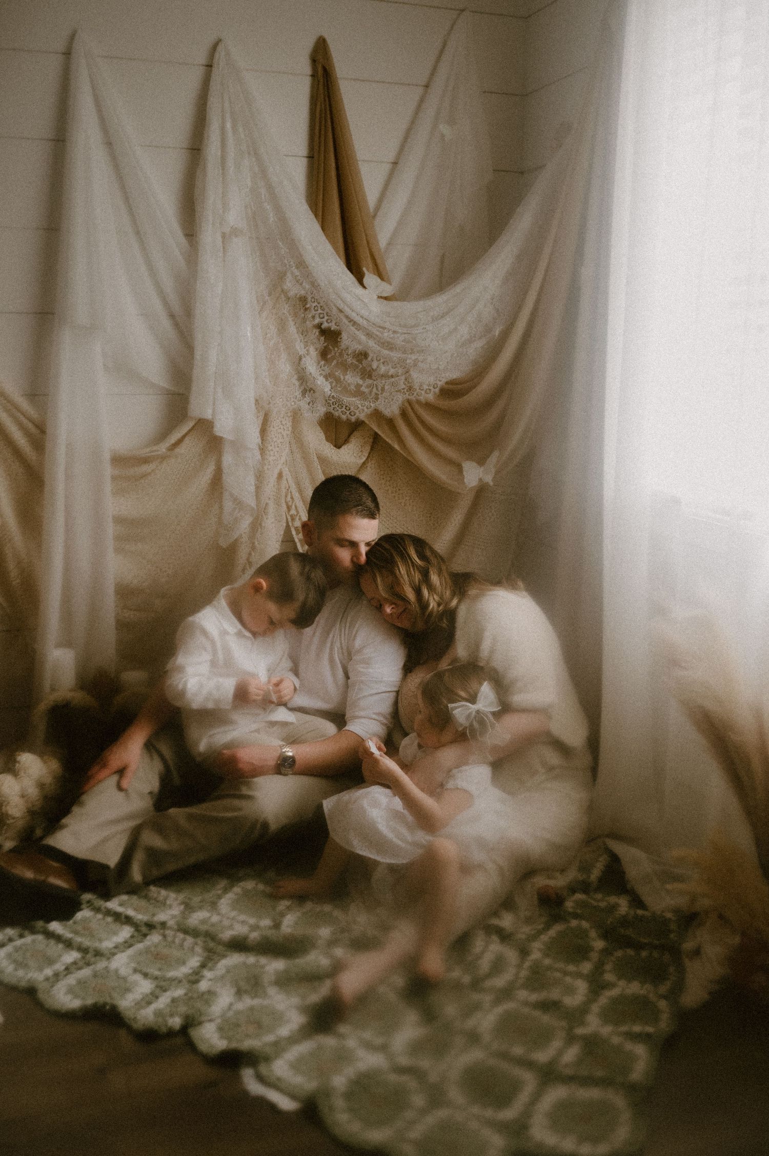 Indiana Storytelling Family Photographer // Intimate indoor portrait session with white fabric backdrop and soft lighting.