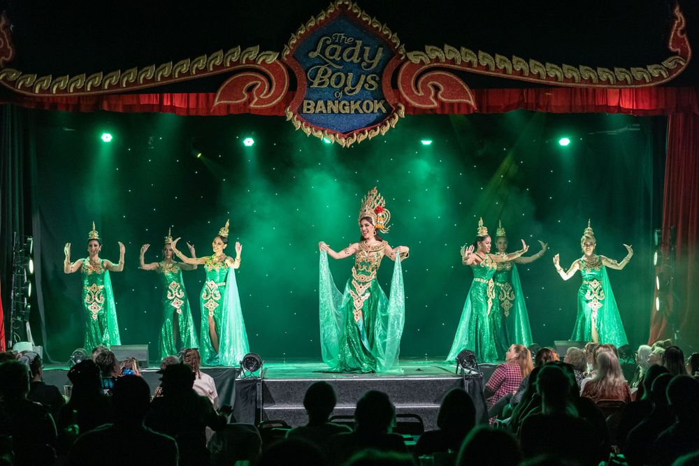 event photography of the Lady boys of Bangkok performing at Brighton fringe festival, dancers on stage wearing green Thai costumes