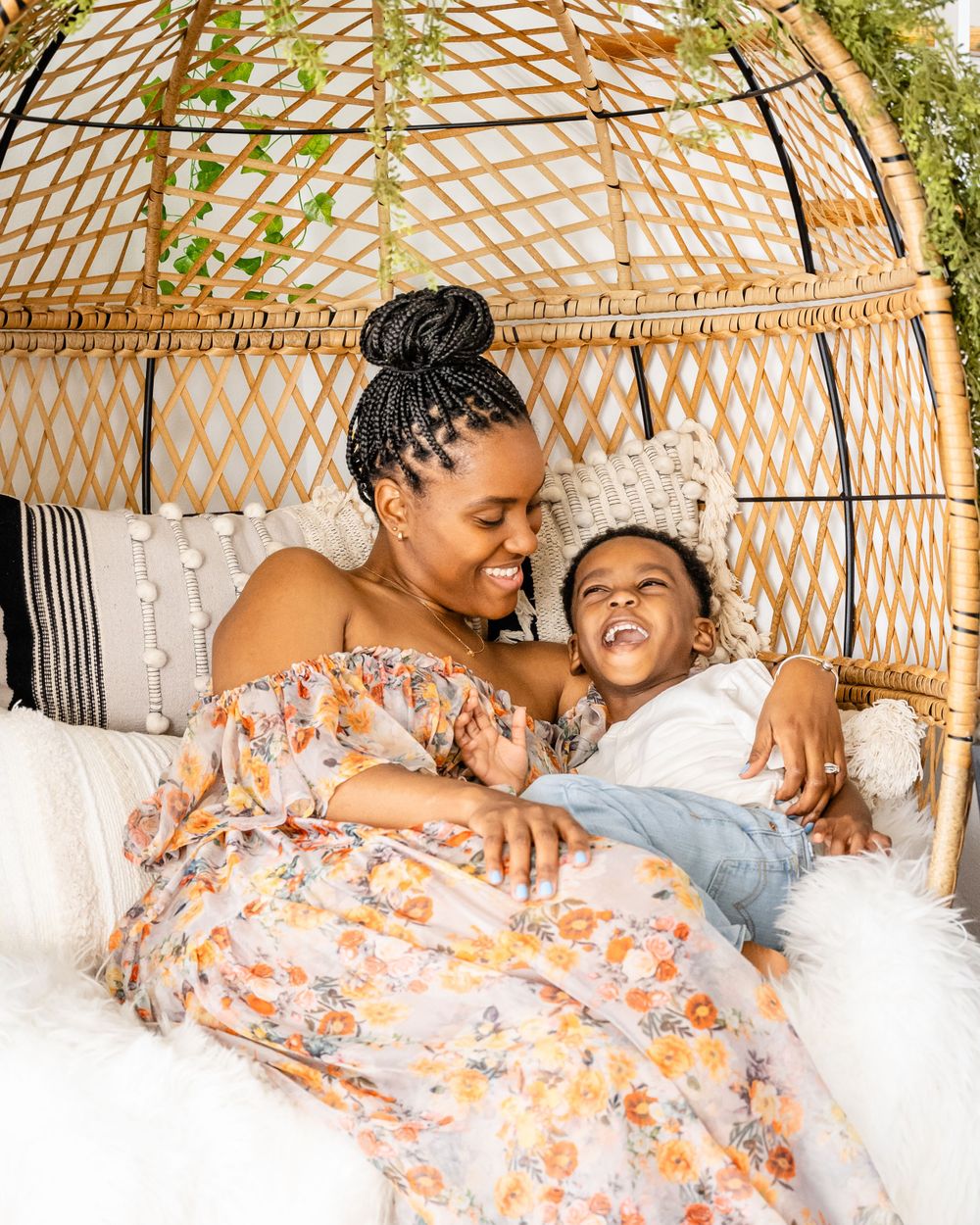 A joyful moment shared between parent and child relaxing in a bohemian yurt setting.