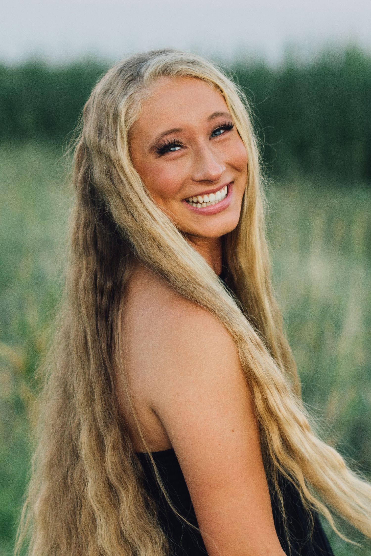 Outdoor portrait series in a natural field setting with soft evening light.