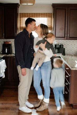 Playful family photos in family's kitchen Chesterfield.  Family photography by Faith Rodriguez. Booking families now for 2026