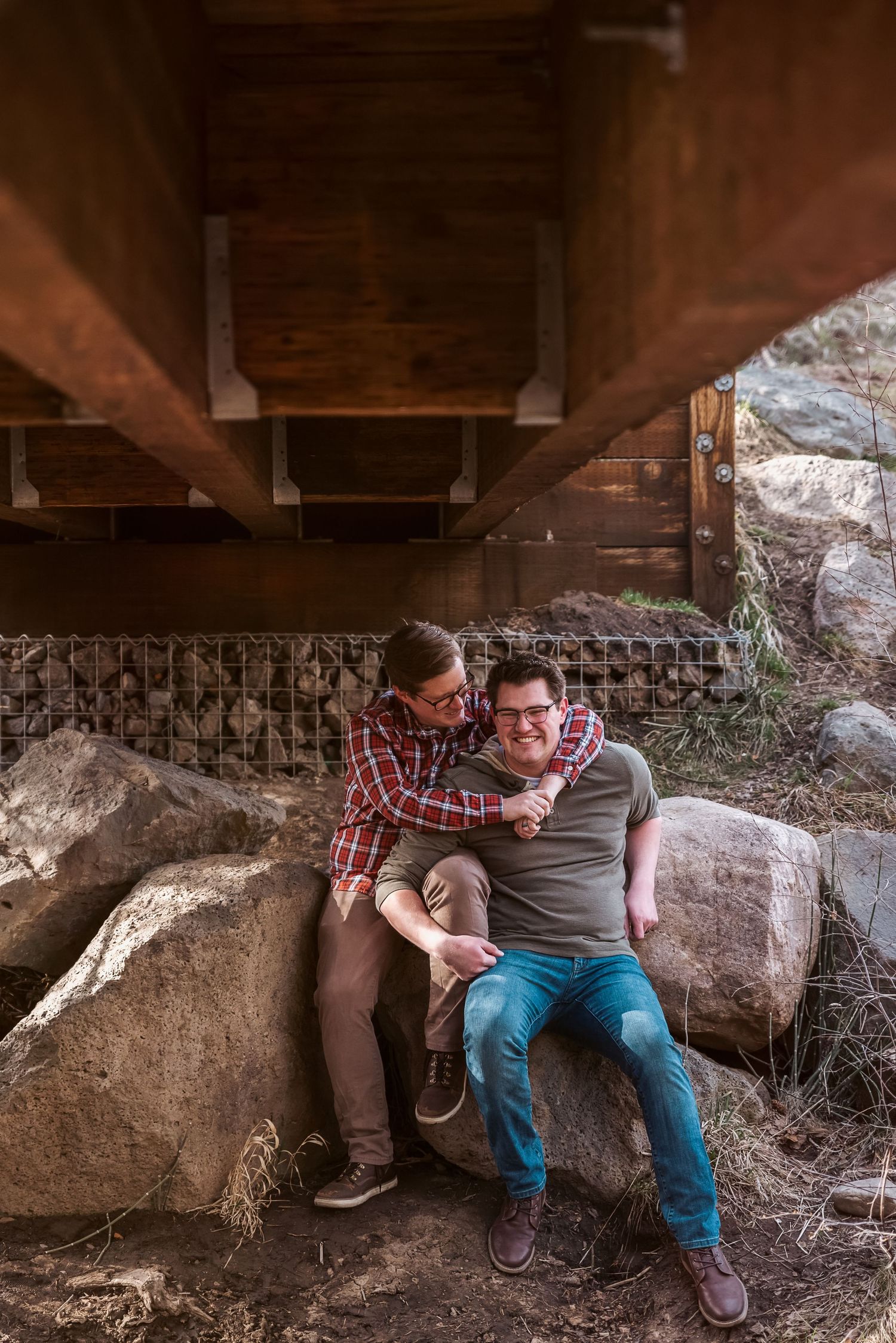 Couple cuddles under bridge at Gibson Jack Trail in Pocatello, Idaho.