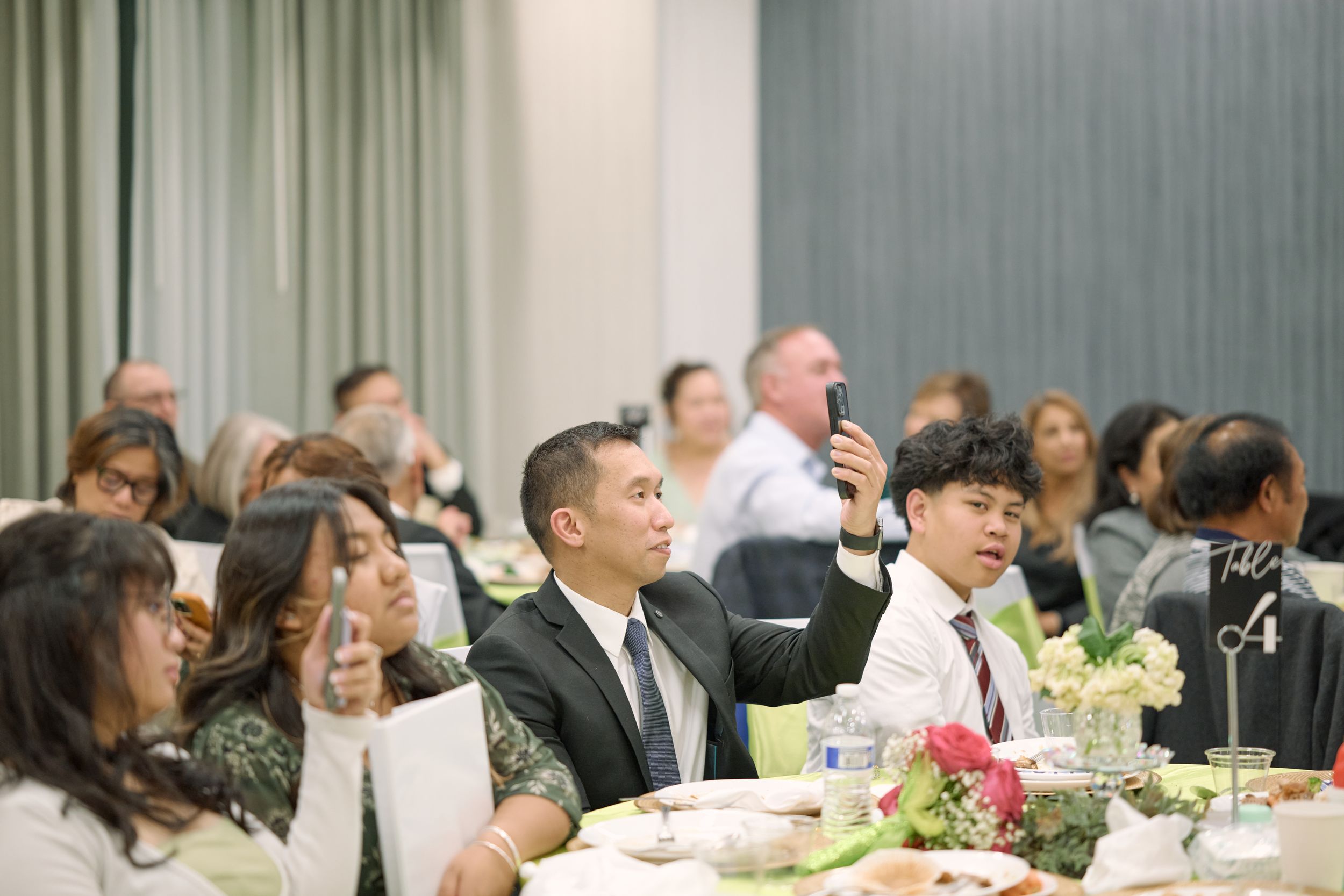 Wedding reception guests seated at elegant tables with floral centerpieces in a modern banquet room at. Fairfield Inn & Suites Lodi, CA.