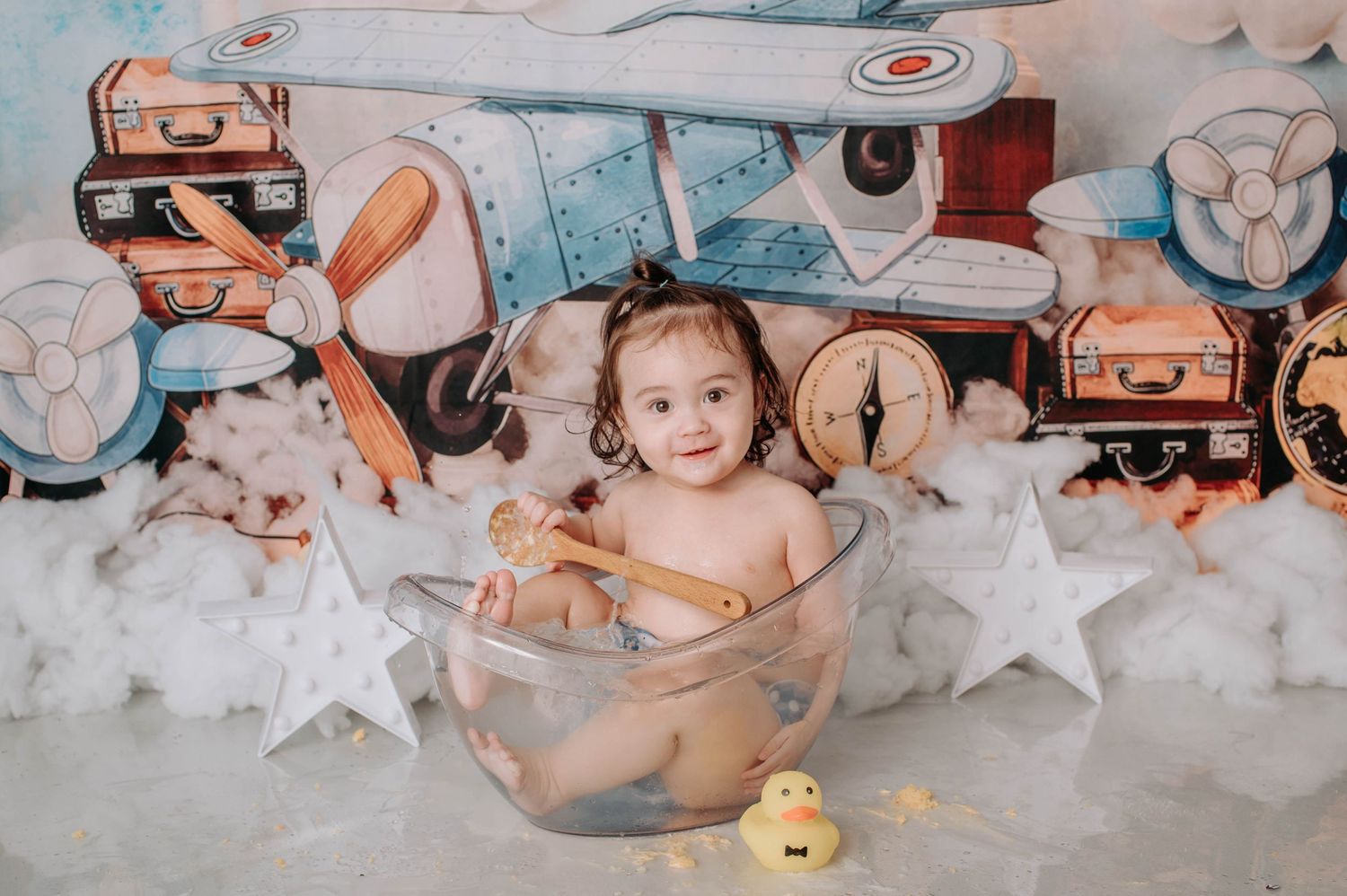 Glass bowl photography setup with rubber duck against vintage aviation backdrop.