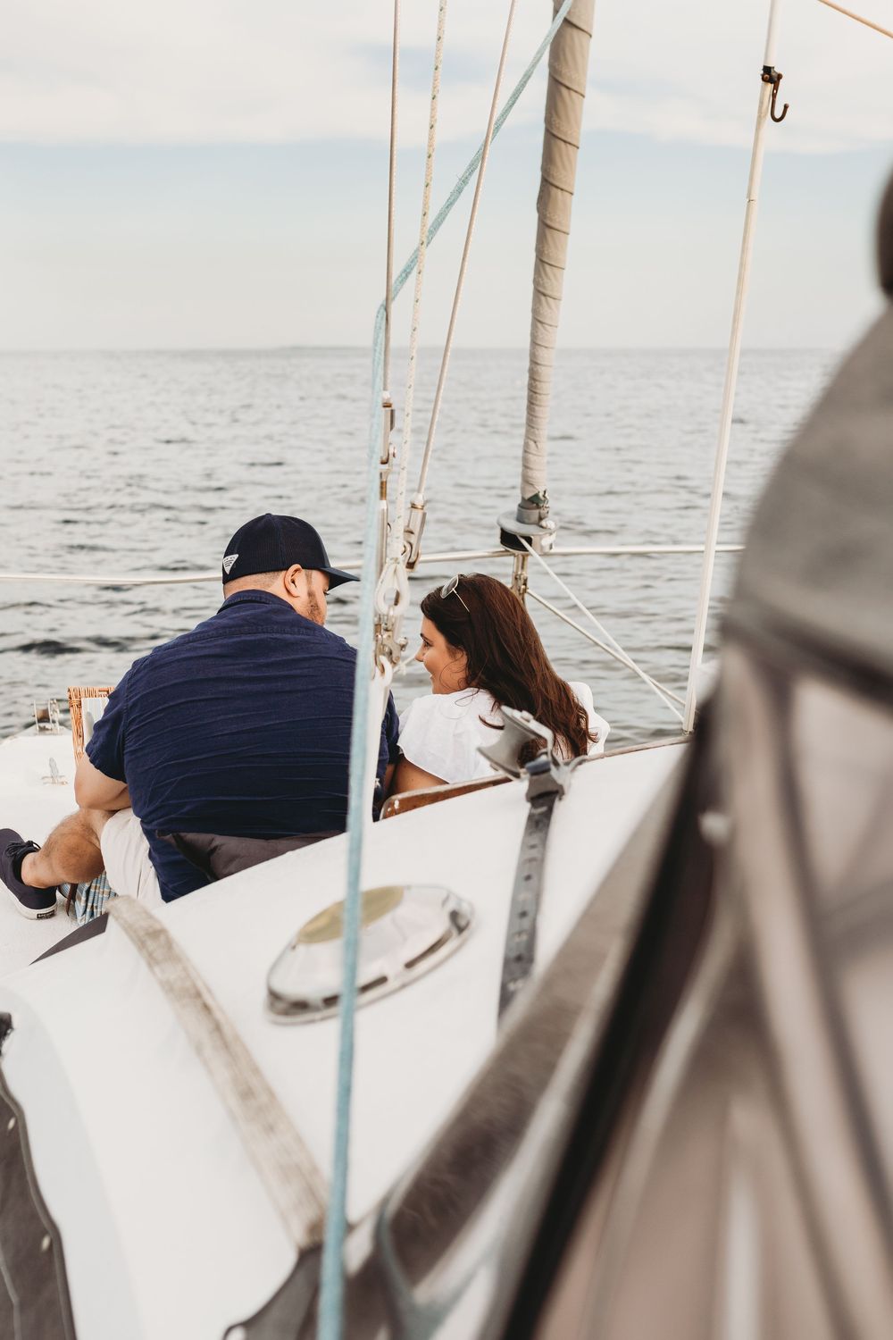 Surprise proposal on a boat near Honeymoon Island Florida with emotional reaction and ocean backdrop