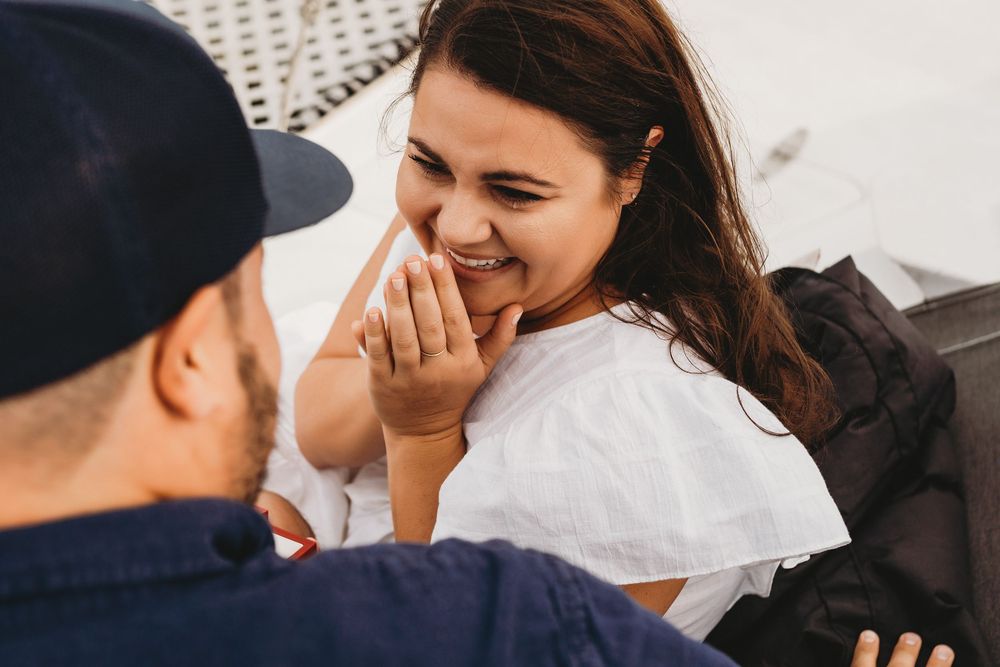 Surprise proposal on a boat near Honeymoon Island Florida with emotional reaction and ocean backdrop