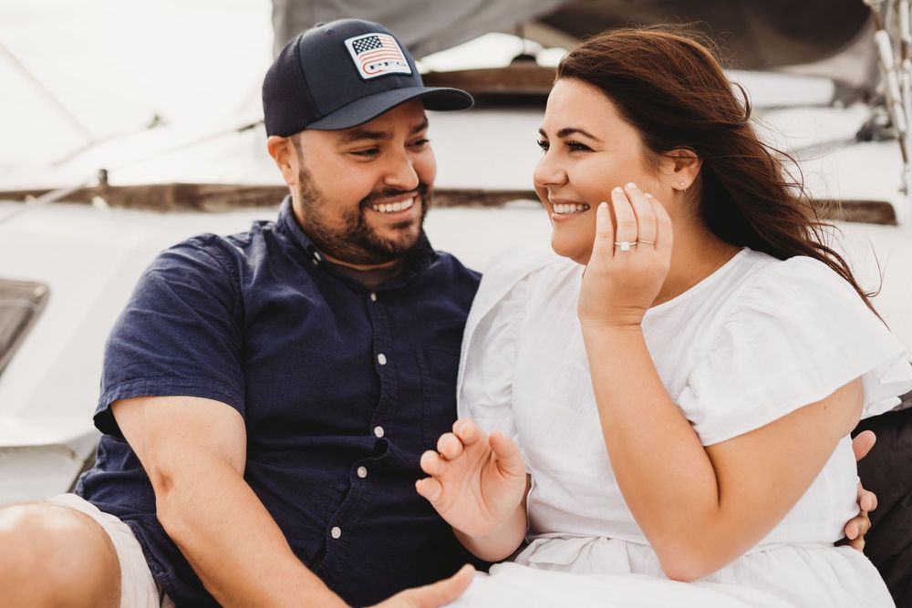 Surprise proposal on a boat near Honeymoon Island Florida with emotional reaction and ocean backdrop