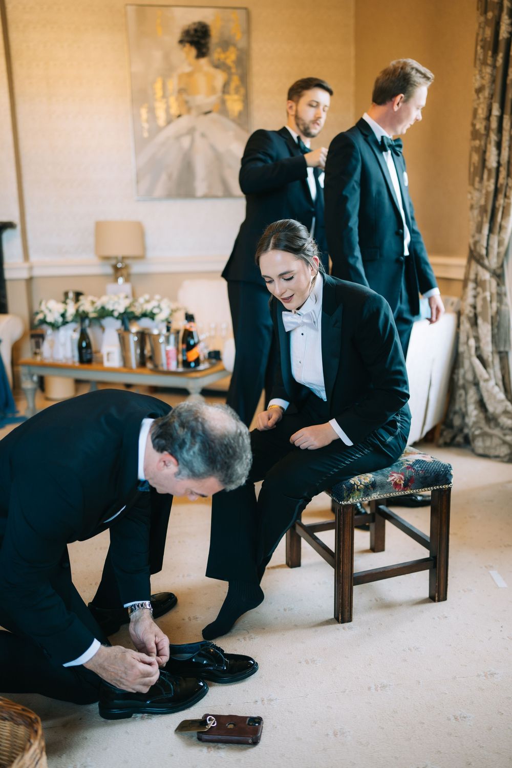 Formal preparations before a wedding with attendants getting ready in a luxurious room.