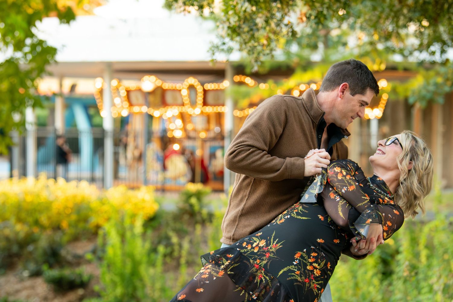 Autumn engagement photoshoot in a garden setting during golden hour.