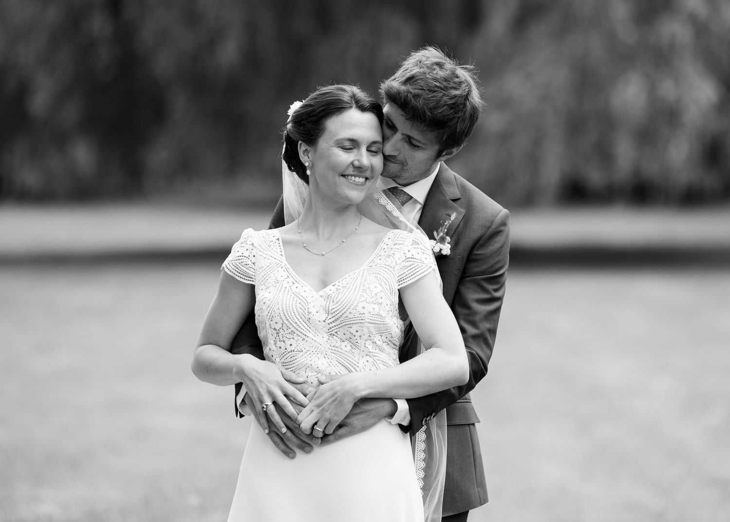 Black and white wedding photos capturing natural romantic moments between newlyweds.