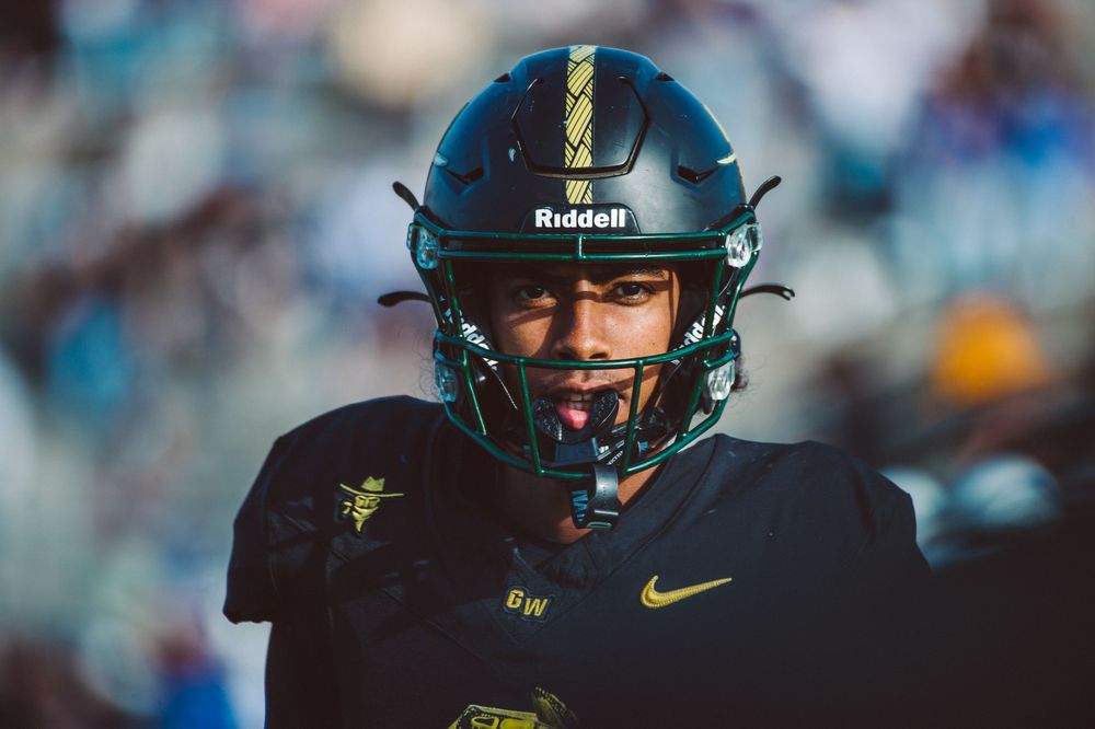 Golden West College football player stares back at the sideline during plays.