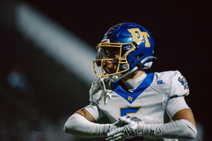 Light shines behind El Toro football player number 5 between plays.