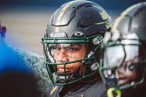 Golden West College quarterback Kauna'oa Kamakawiwo'ole looks towards the coin toss as a team captain before the state championship game.