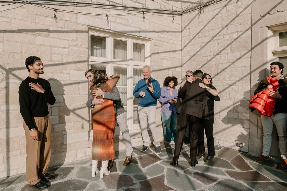A series of candid moments showing couples dancing and embracing on stone steps outside a building.