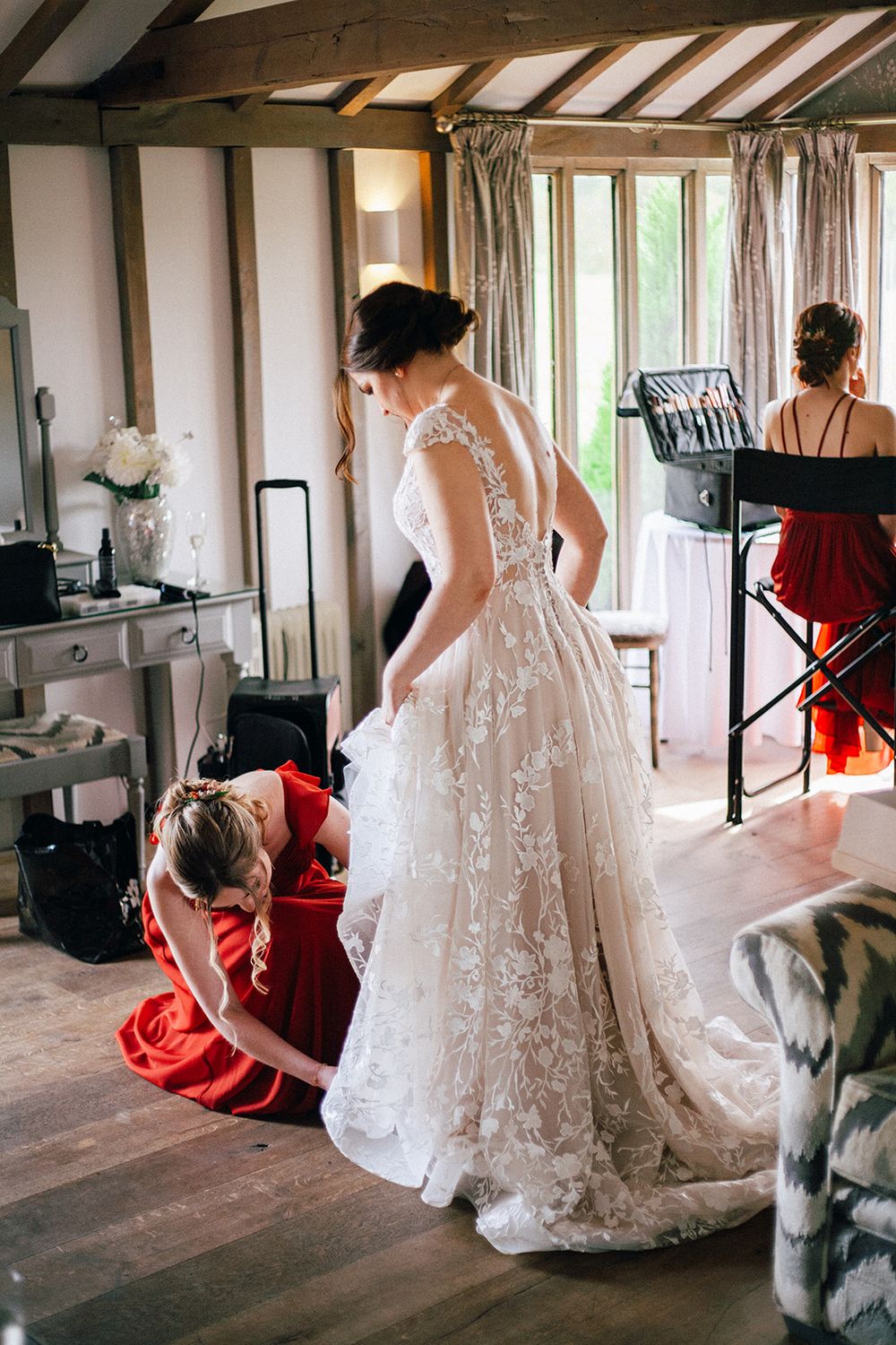 A series of four wedding photos showing a bride in a lace gown with a musician in red performing in a rustic venue.