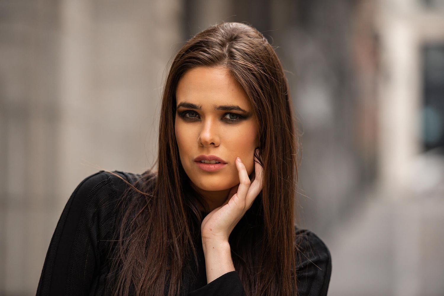 Fashion portrait in urban setting with soft lighting.