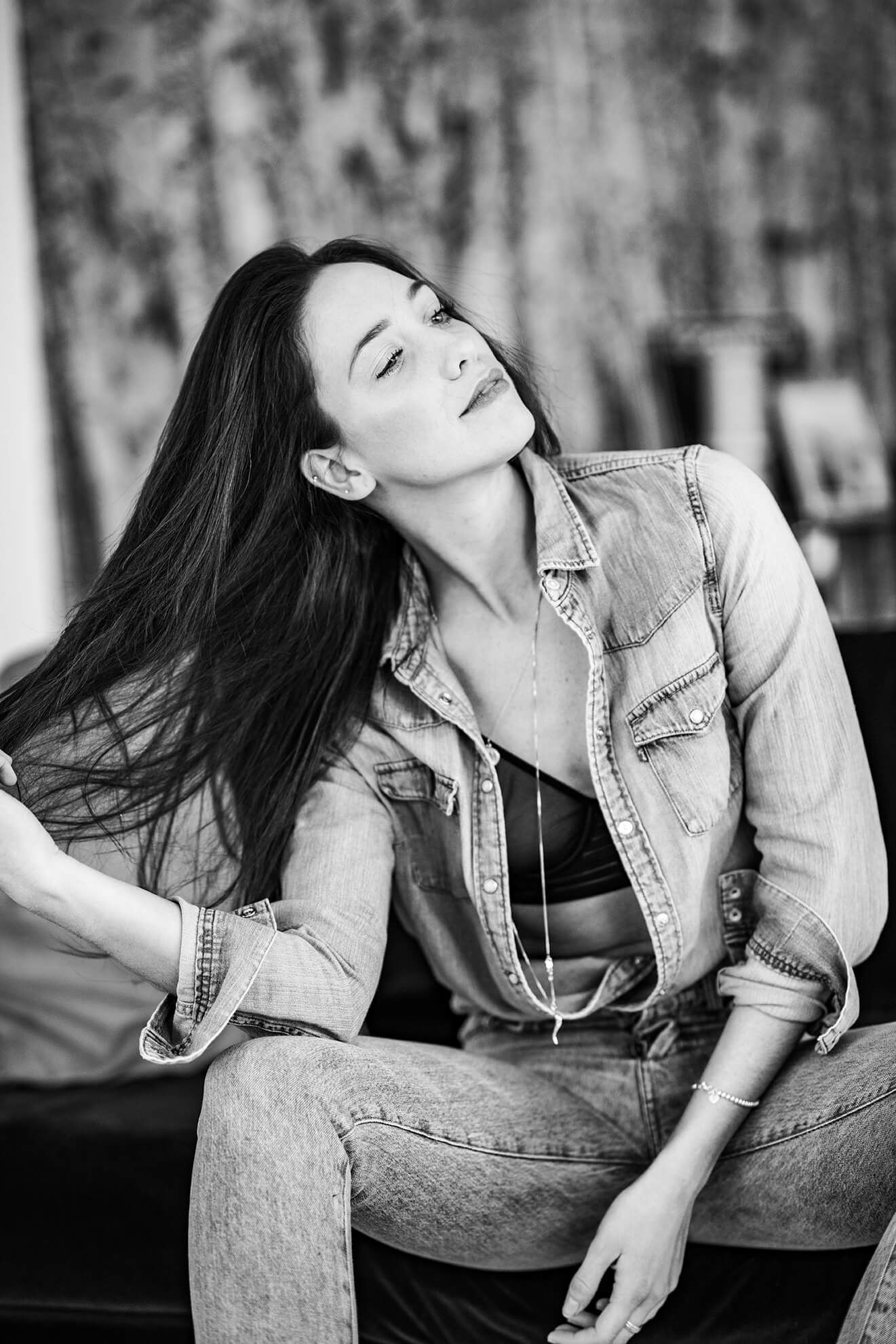 Black and white portrait series showing expressive poses in casual denim attire.