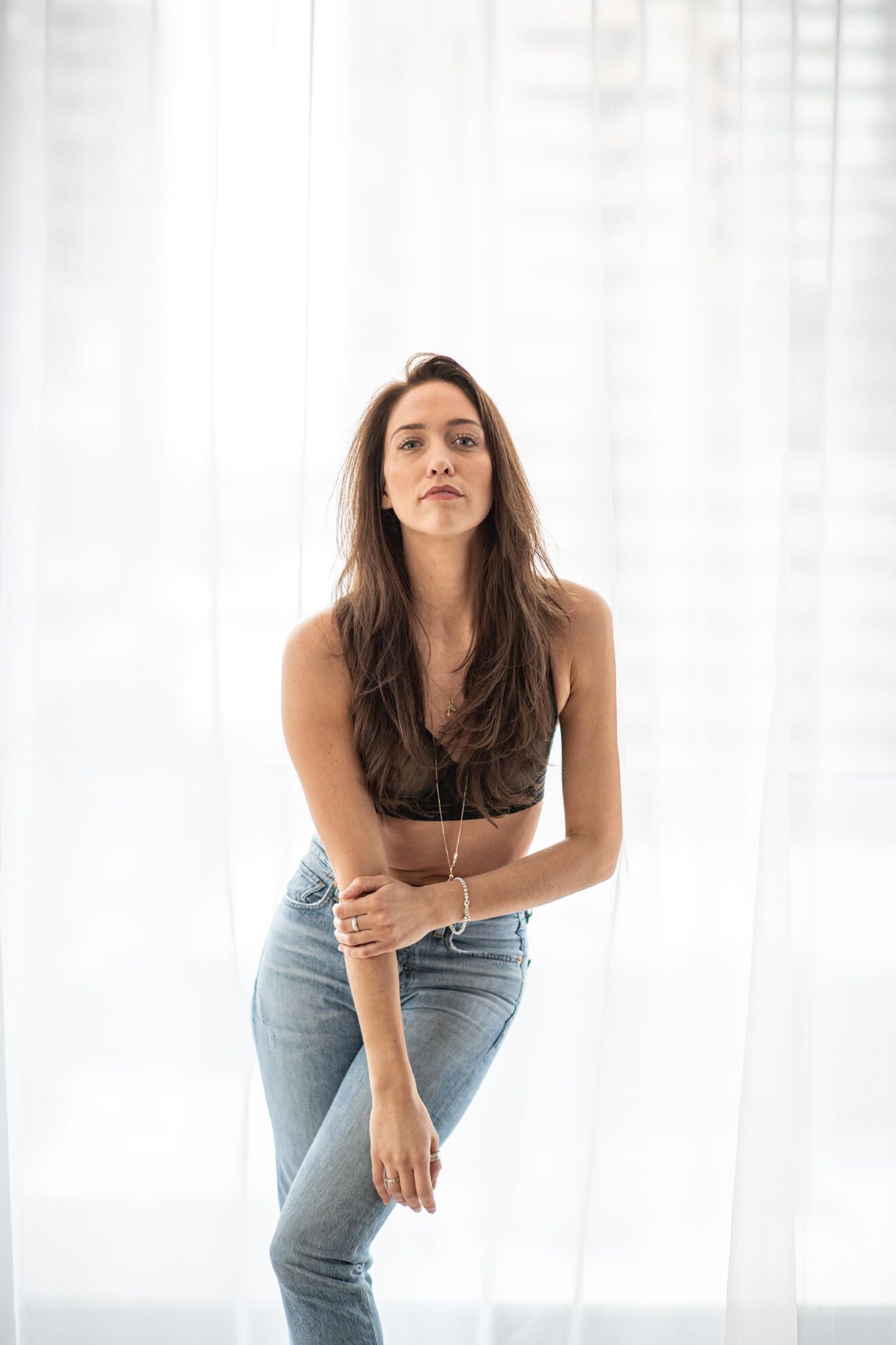 Casual fashion portraits featuring denim and black top styling against bright white background.