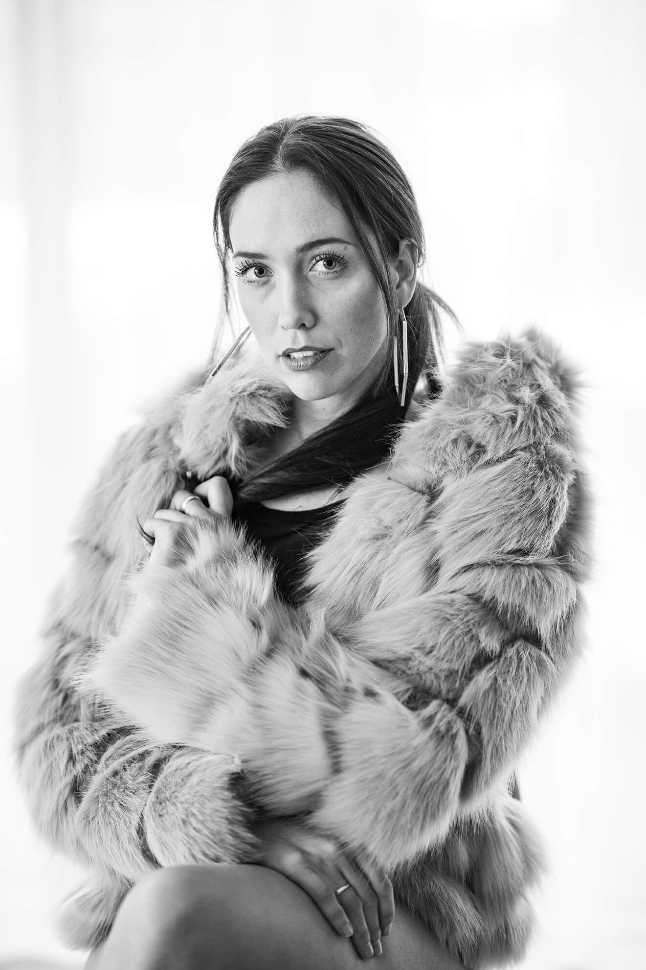 Black and white portrait series showcasing elegant poses in fur coat.