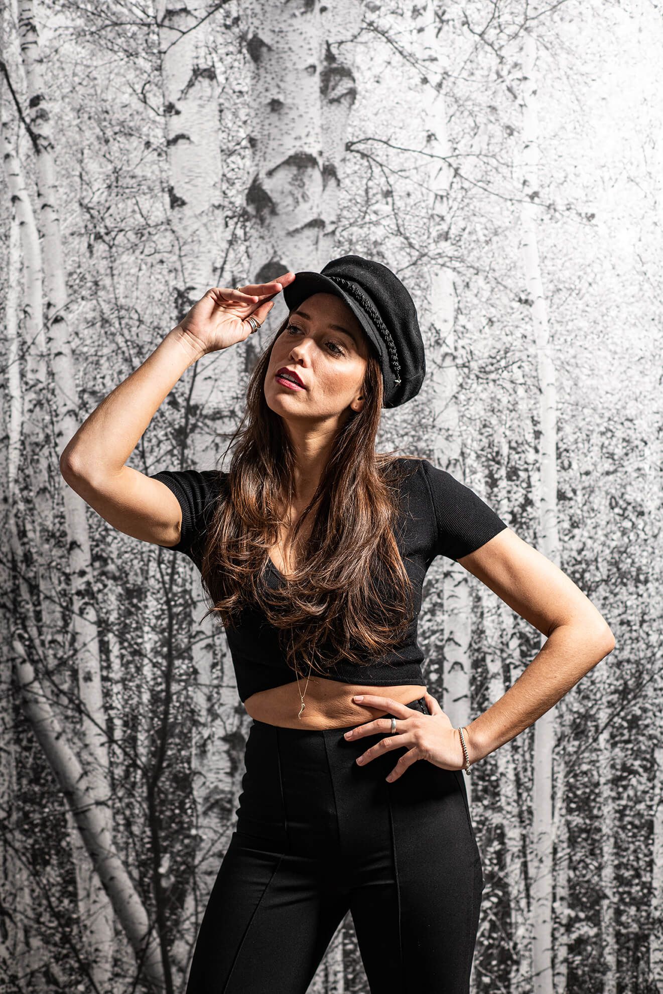 Fashion portraits against a textured birch forest background.