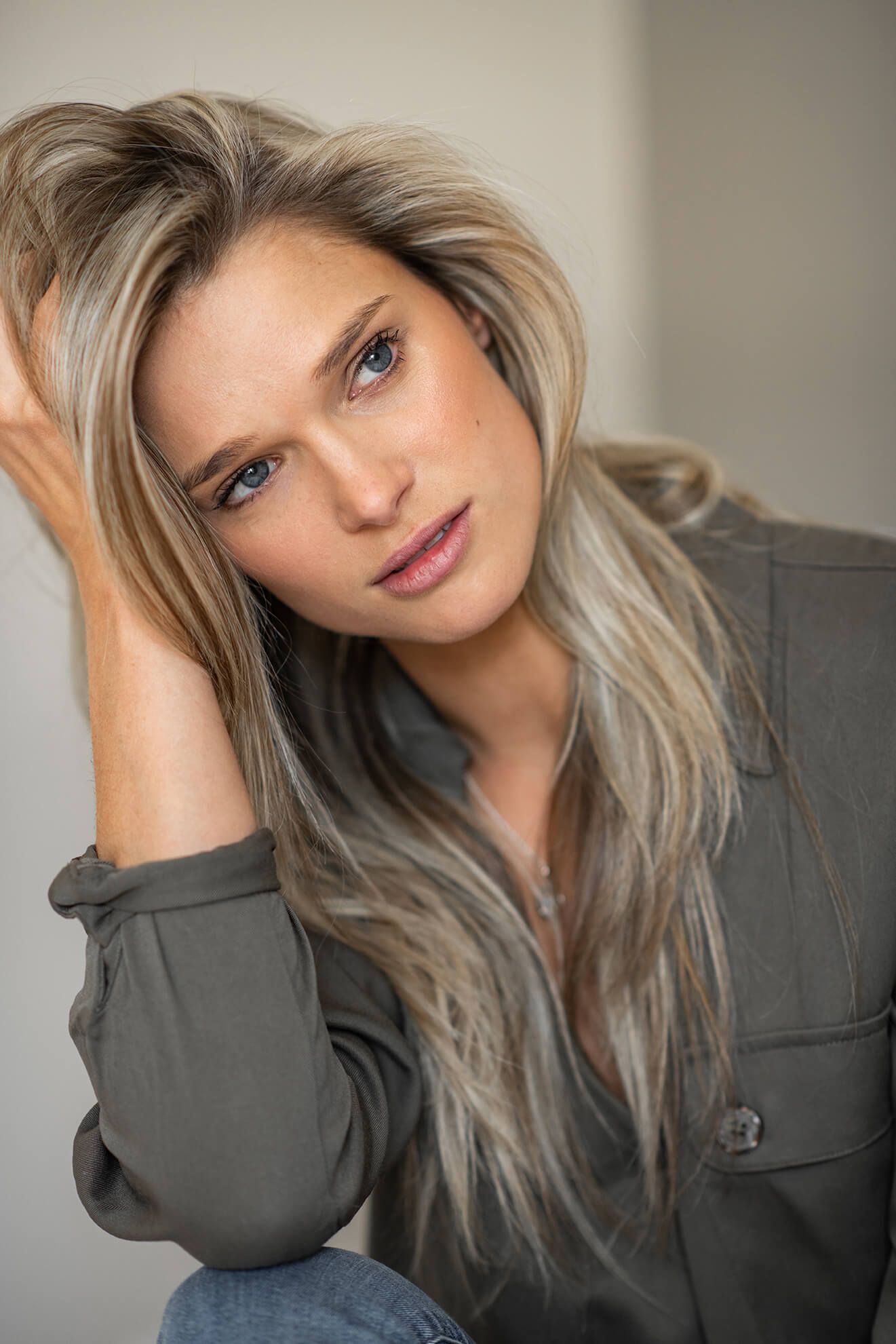 Close-up portrait series with grey blazer against neutral background.