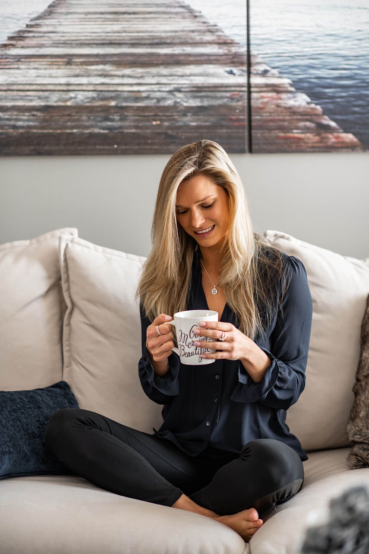 Relaxed lifestyle photos of someone lounging on a white couch with a coffee cup.