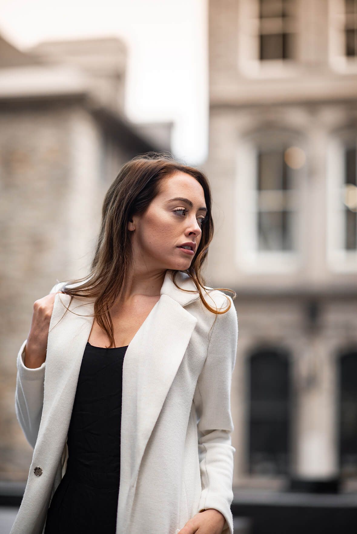 Sophisticated white blazer styling captured in a series of urban fashion portraits.