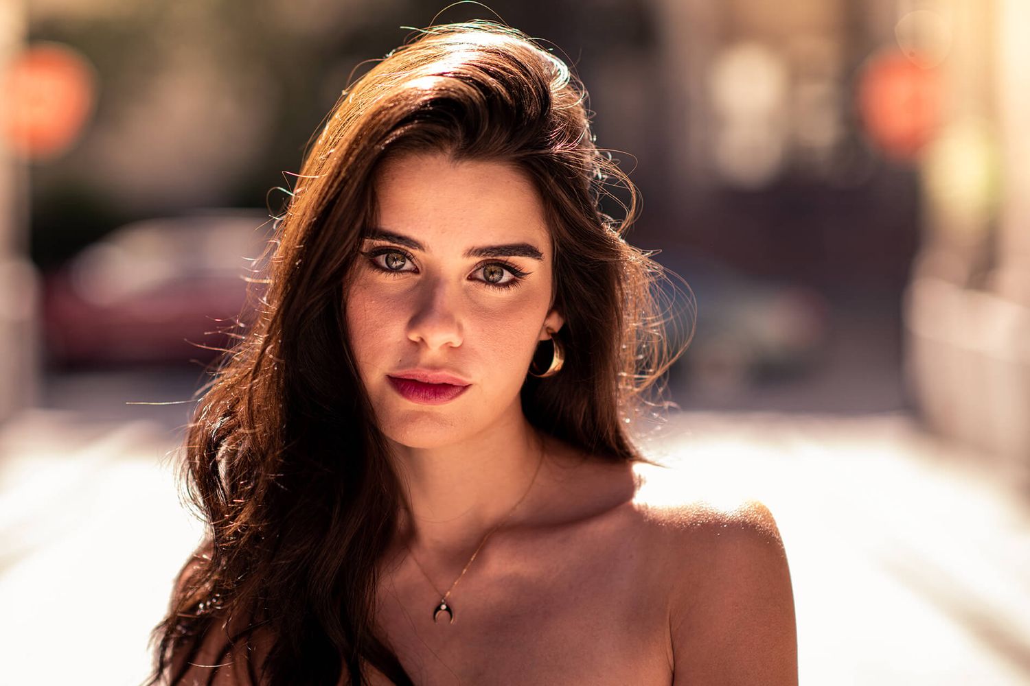 Sunlit fashion portrait with dramatic lighting and soft focus effects.