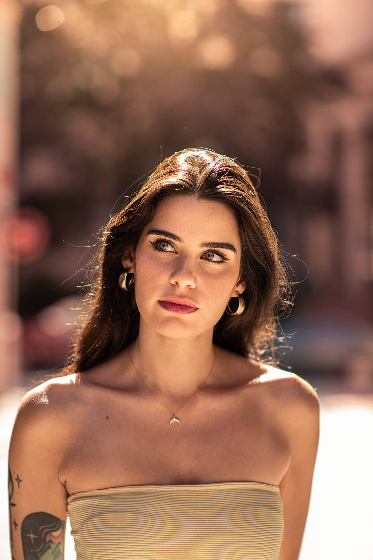 Summer fashion portrait in warm golden light wearing strapless top.
