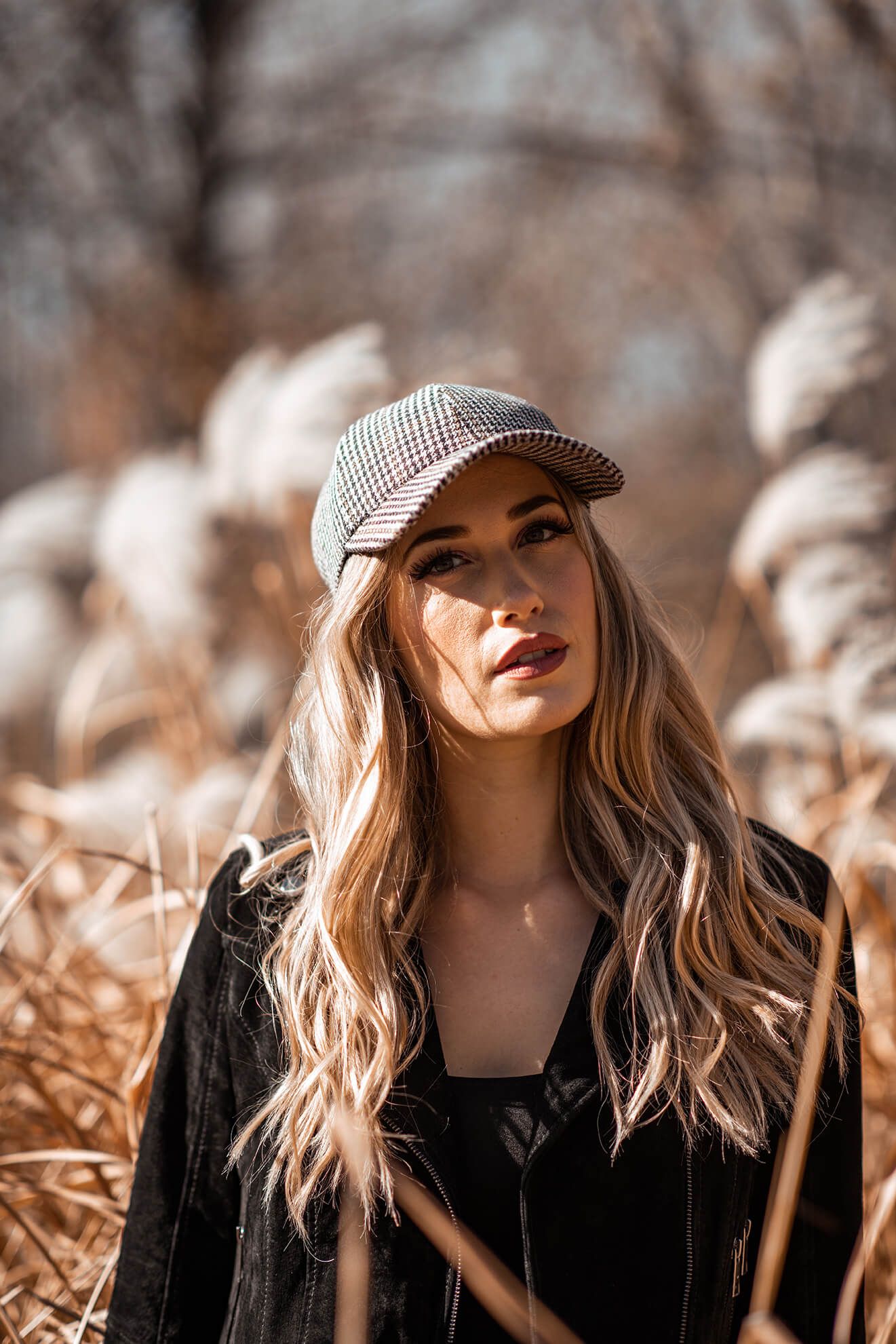 Stylish outdoor photography series with golden lighting and a checkered cap.