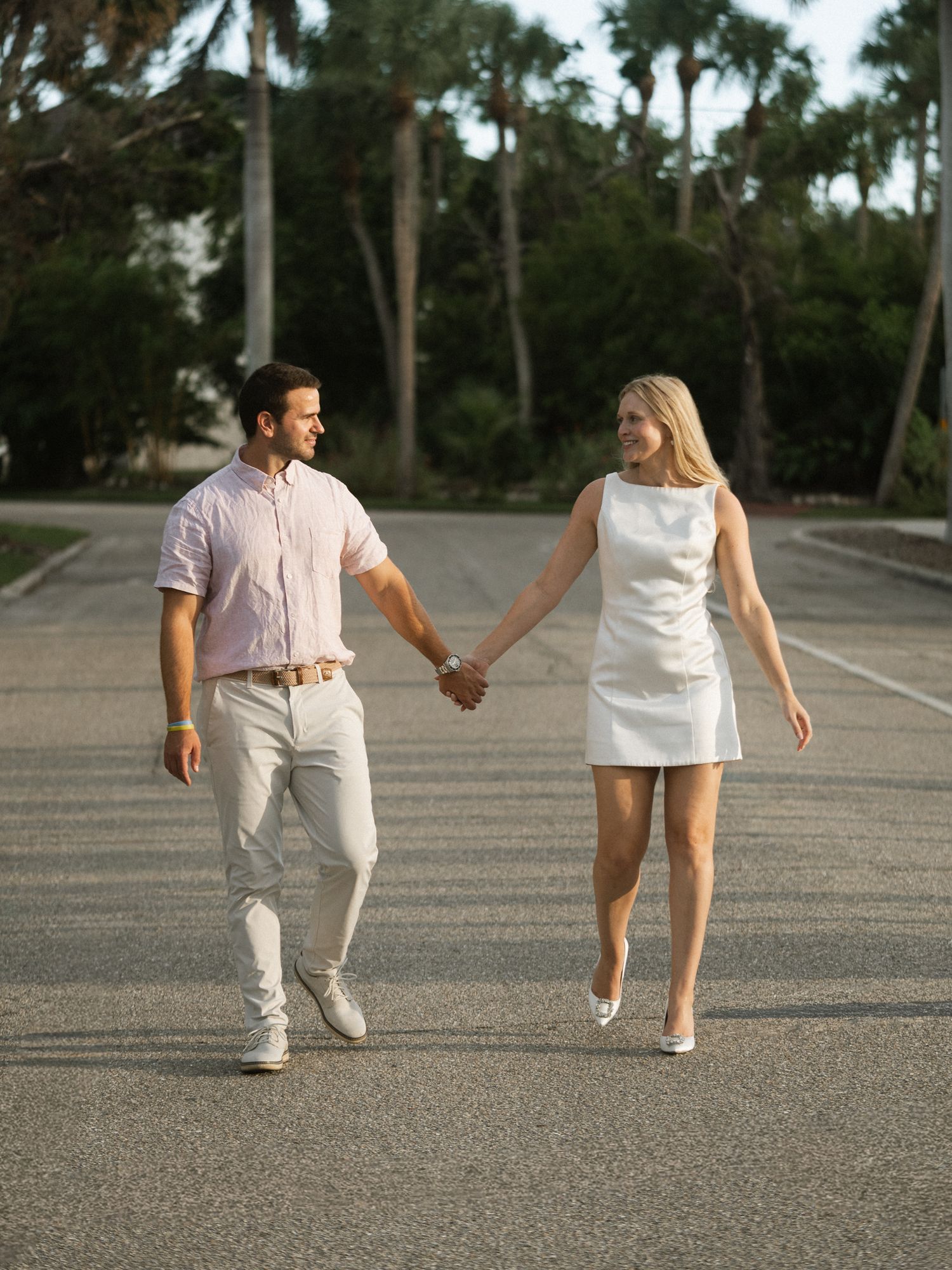A sequence of photos showing a couple walking hand in hand across a paved outdoor area.