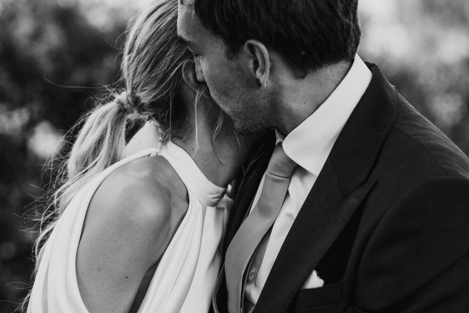Intimate romantic moment captured in black and white portrait style.