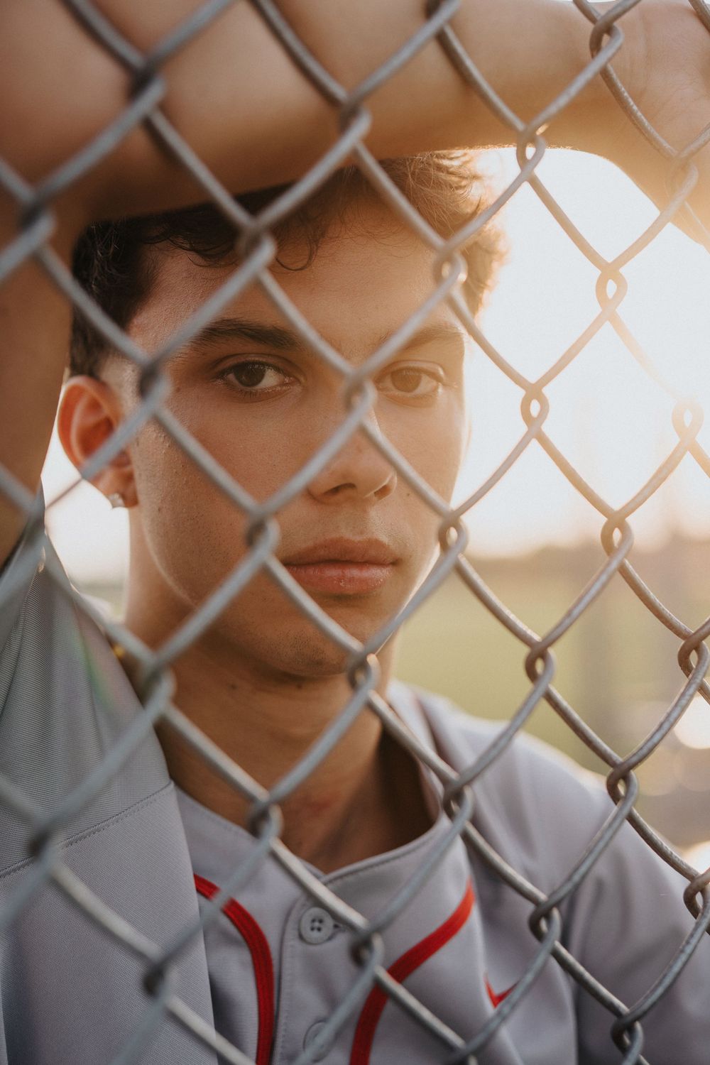 Close up view through chain link fence during golden hour lighting.