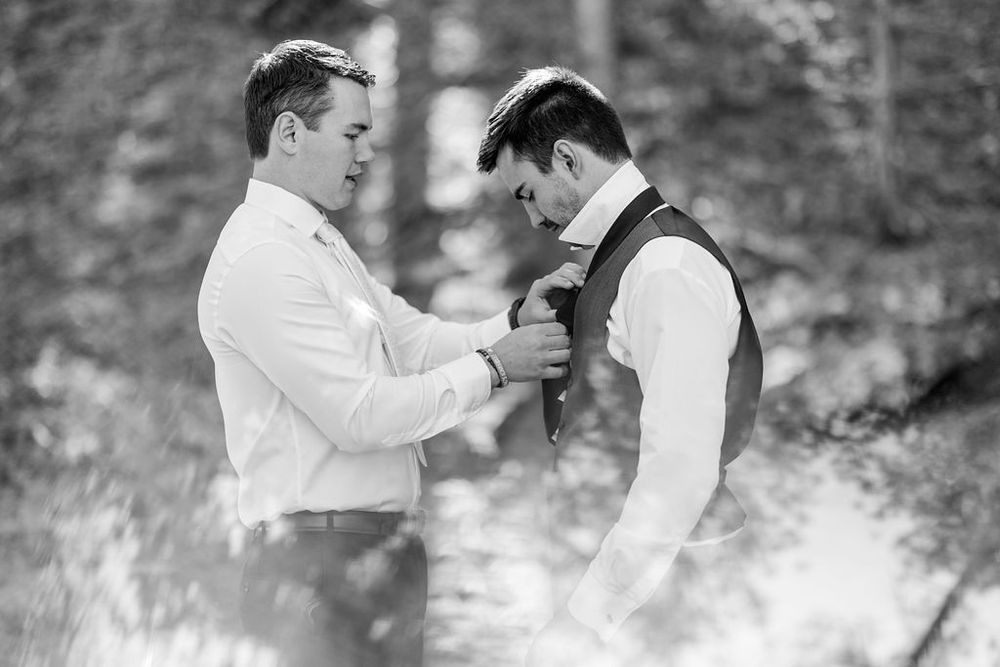 Black and white photo series showing a romantic couple dancing together in an outdoor garden setting.