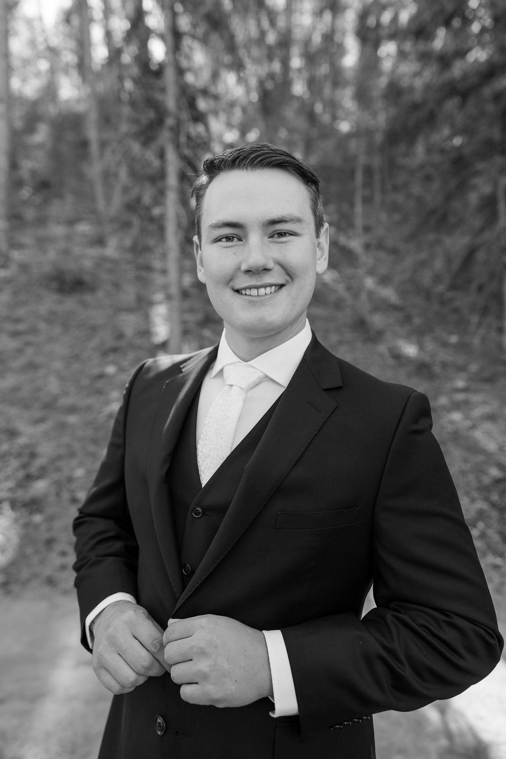 A formal portrait series showing someone in a black tuxedo against a wooded background.