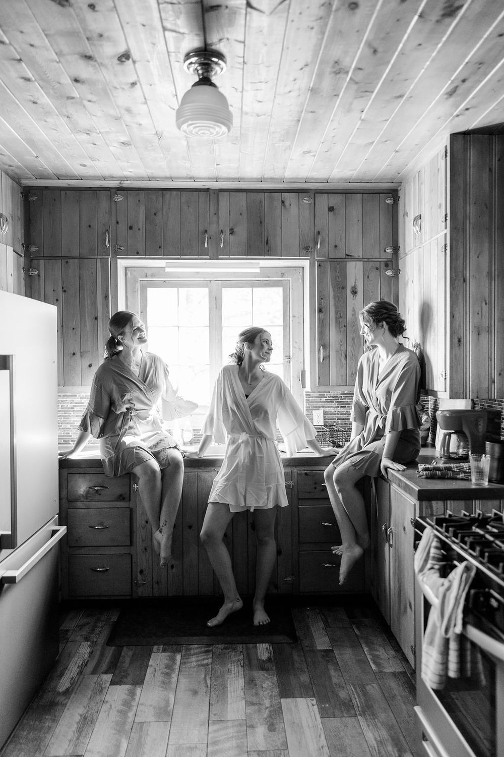 A series of black and white photos showing movement and activity inside a rustic wooden cabin interior.