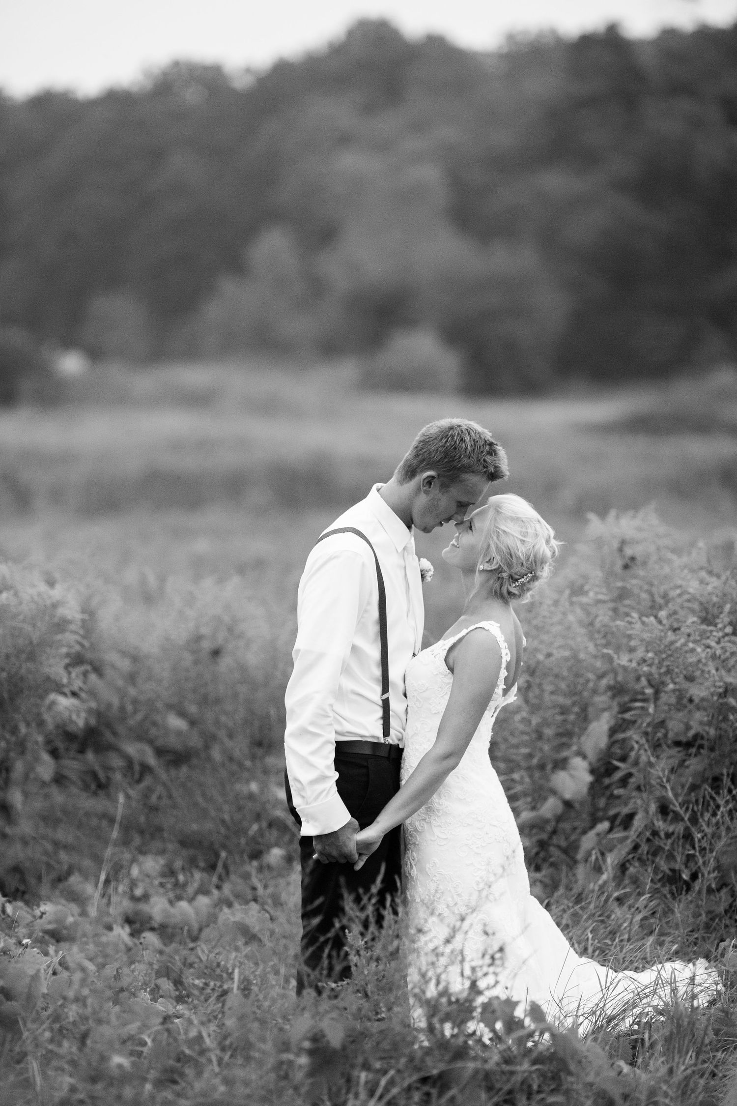 A romantic black and white wedding photo sequence shows a couple embracing in a wildflower meadow.