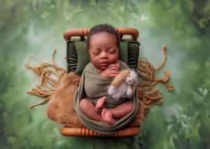 Sleeping newborn wrapped in green swaddle holding stuffed animal in wooden chair on green textured background.
