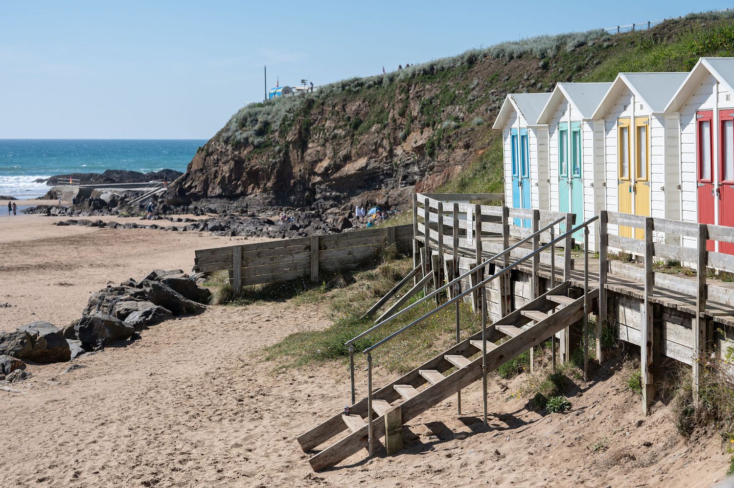 Colourful beach huts at Bude Beach in Cornwall, a micro wedding venue