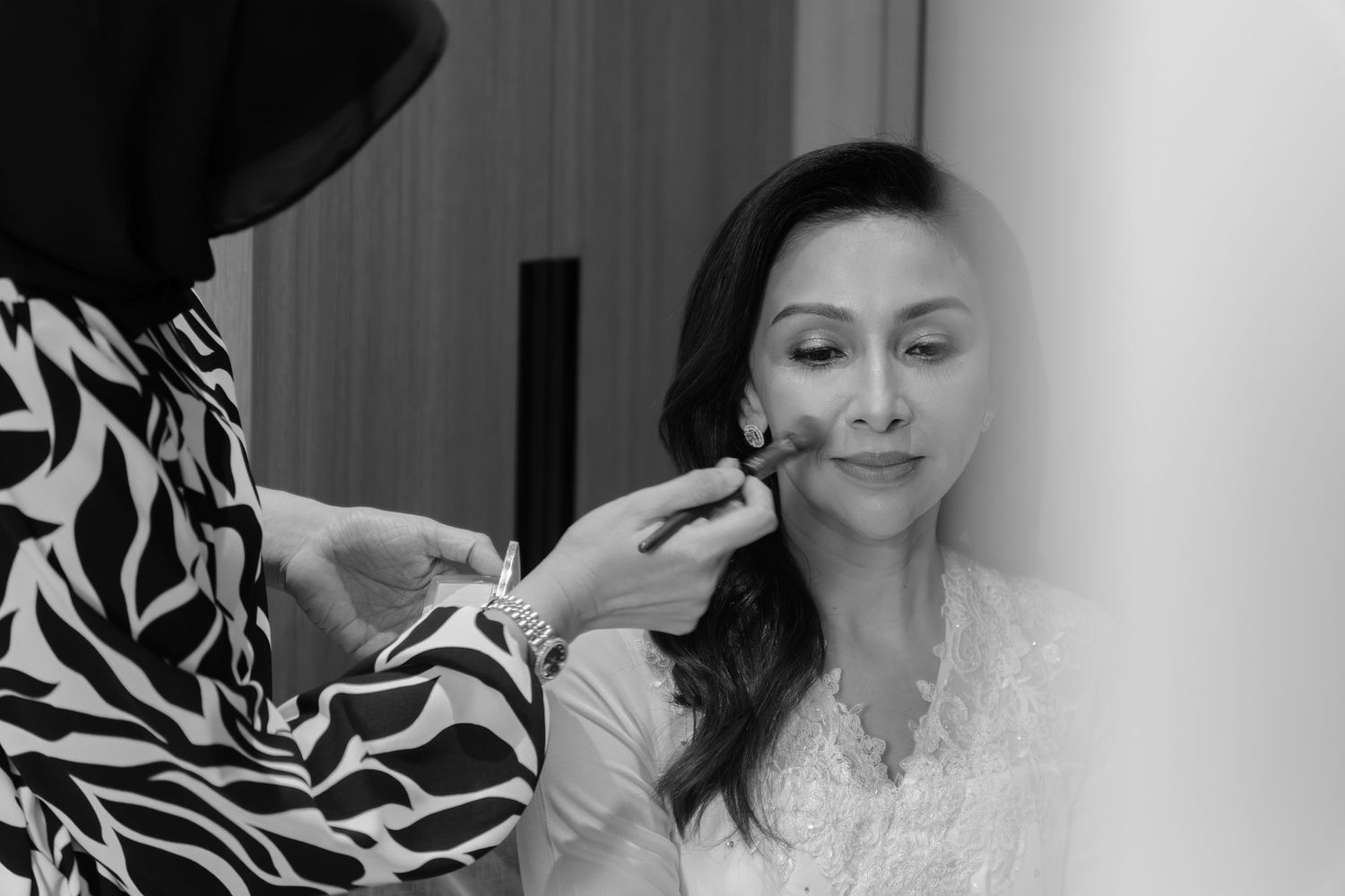A black and white photo collage showing intimate moments between a couple during their wedding day.