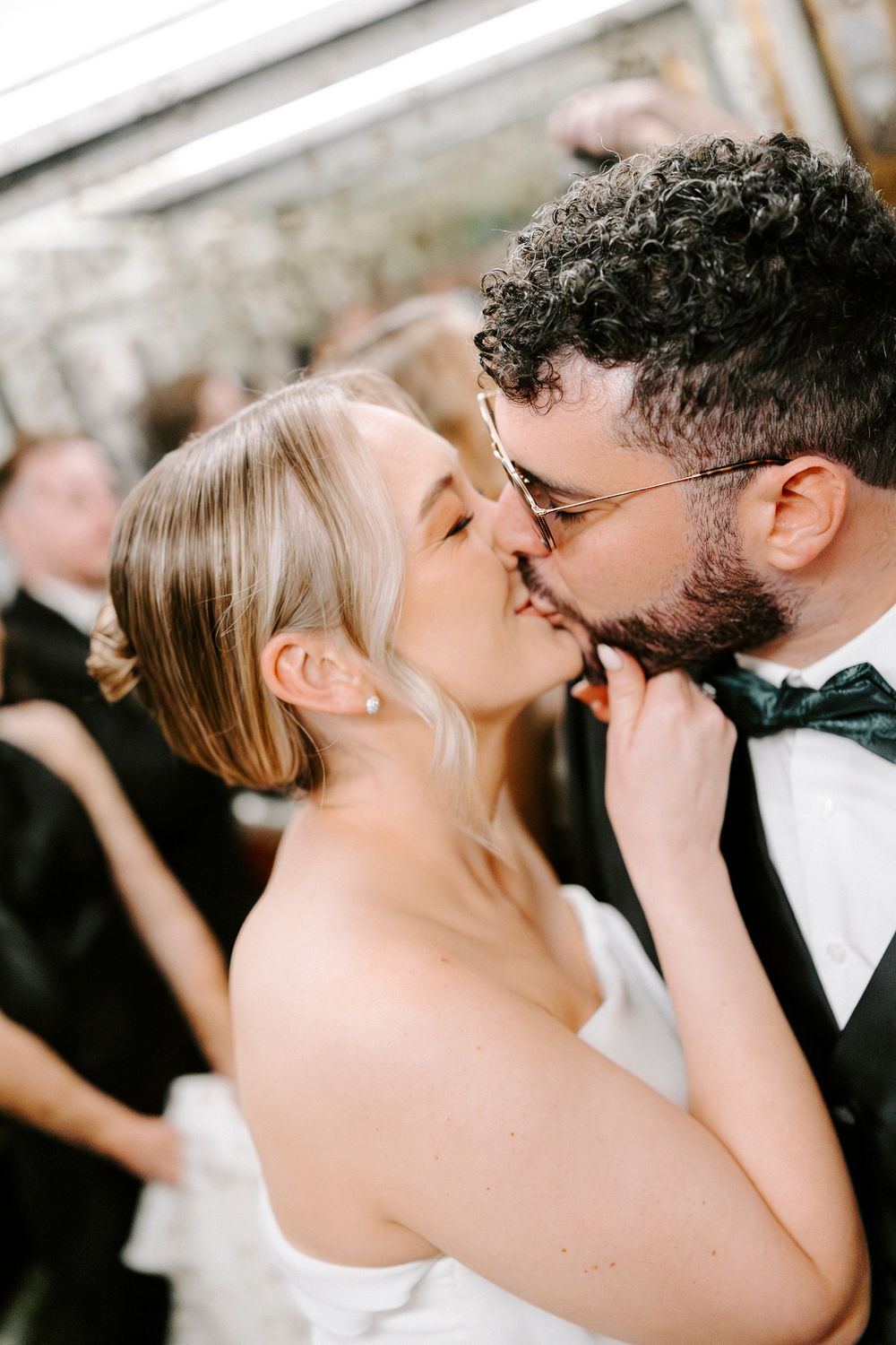 A sequence of romantic wedding kisses captured in black and white photography.