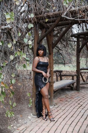 A series of artistic outdoor portraits taken on a curved brick path under tree branches in natural lighting.