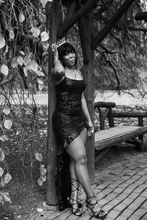 Black and white artistic portraits captured on a winding brick walkway beneath overhanging foliage.