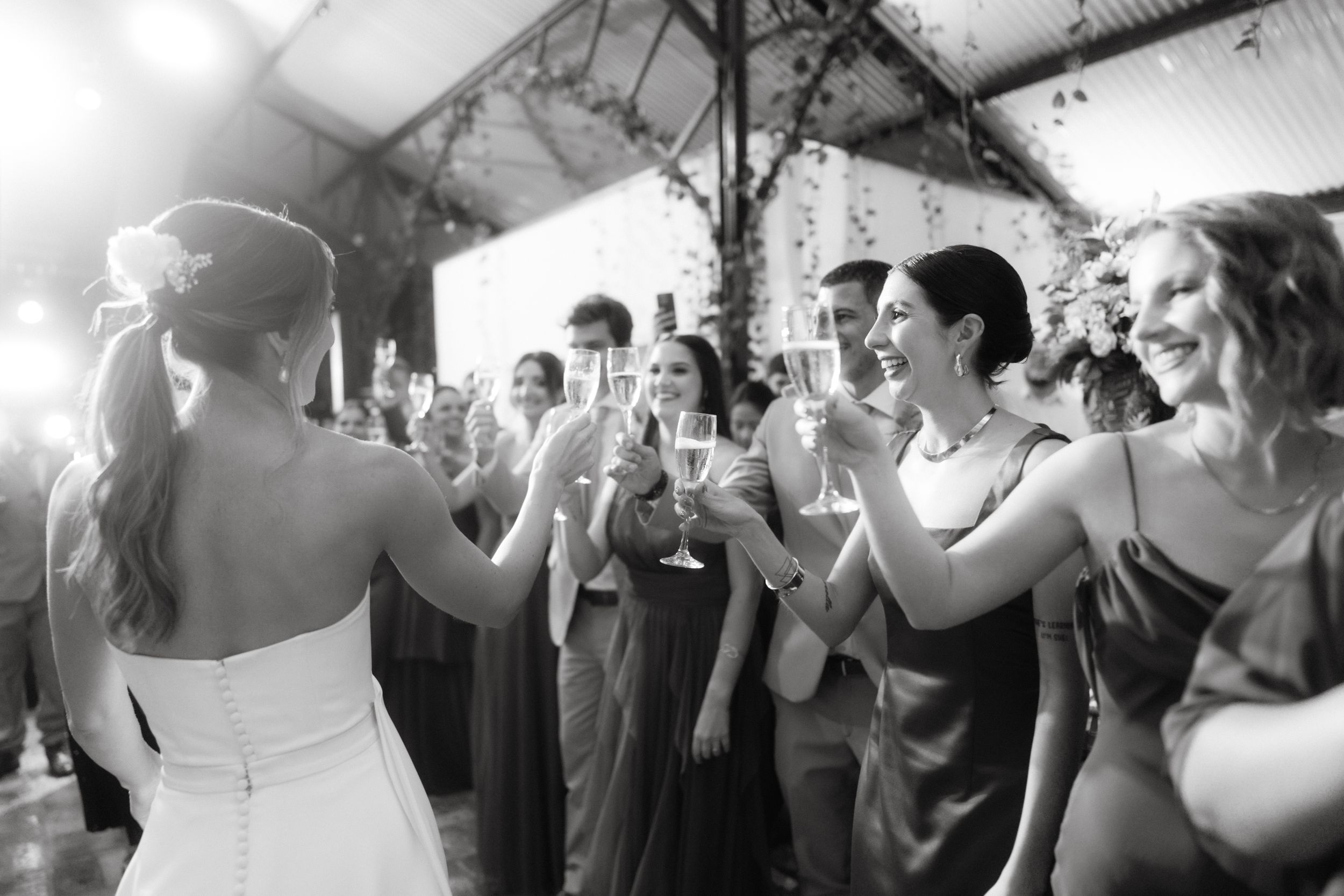 Wedding guests toasting and celebrating during reception party.