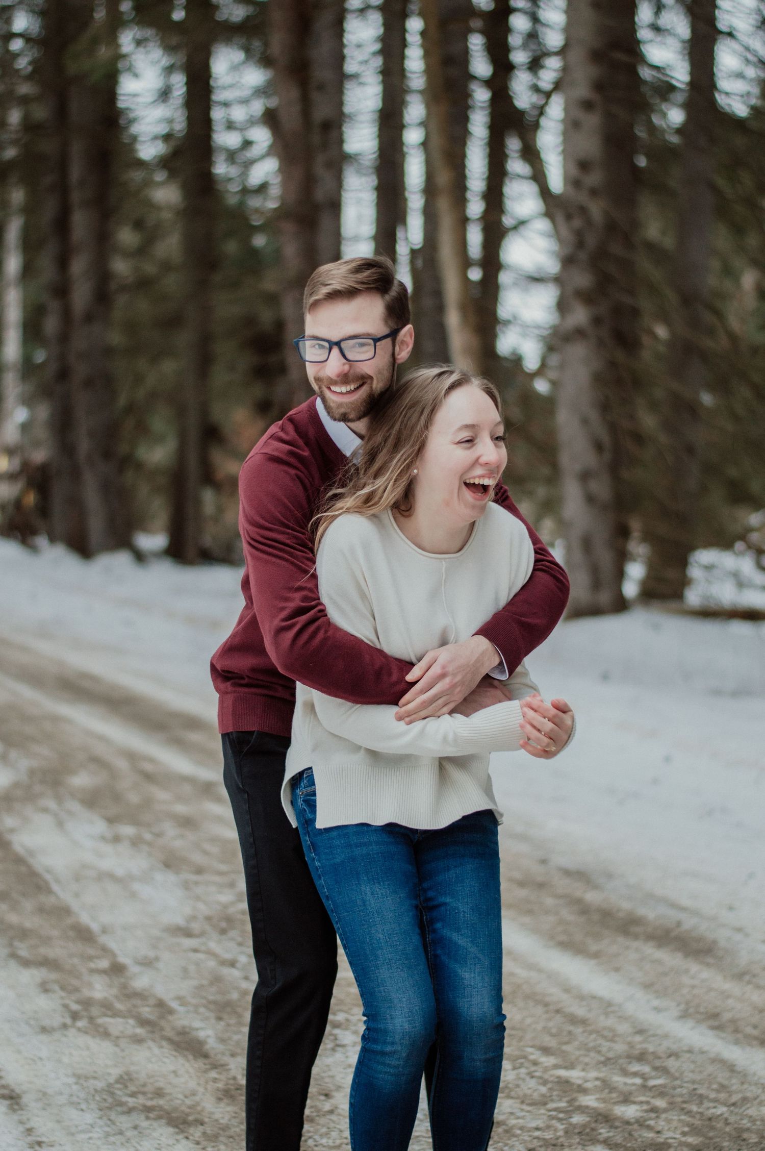 Engaged couple laughing in the woods. Western NY.
