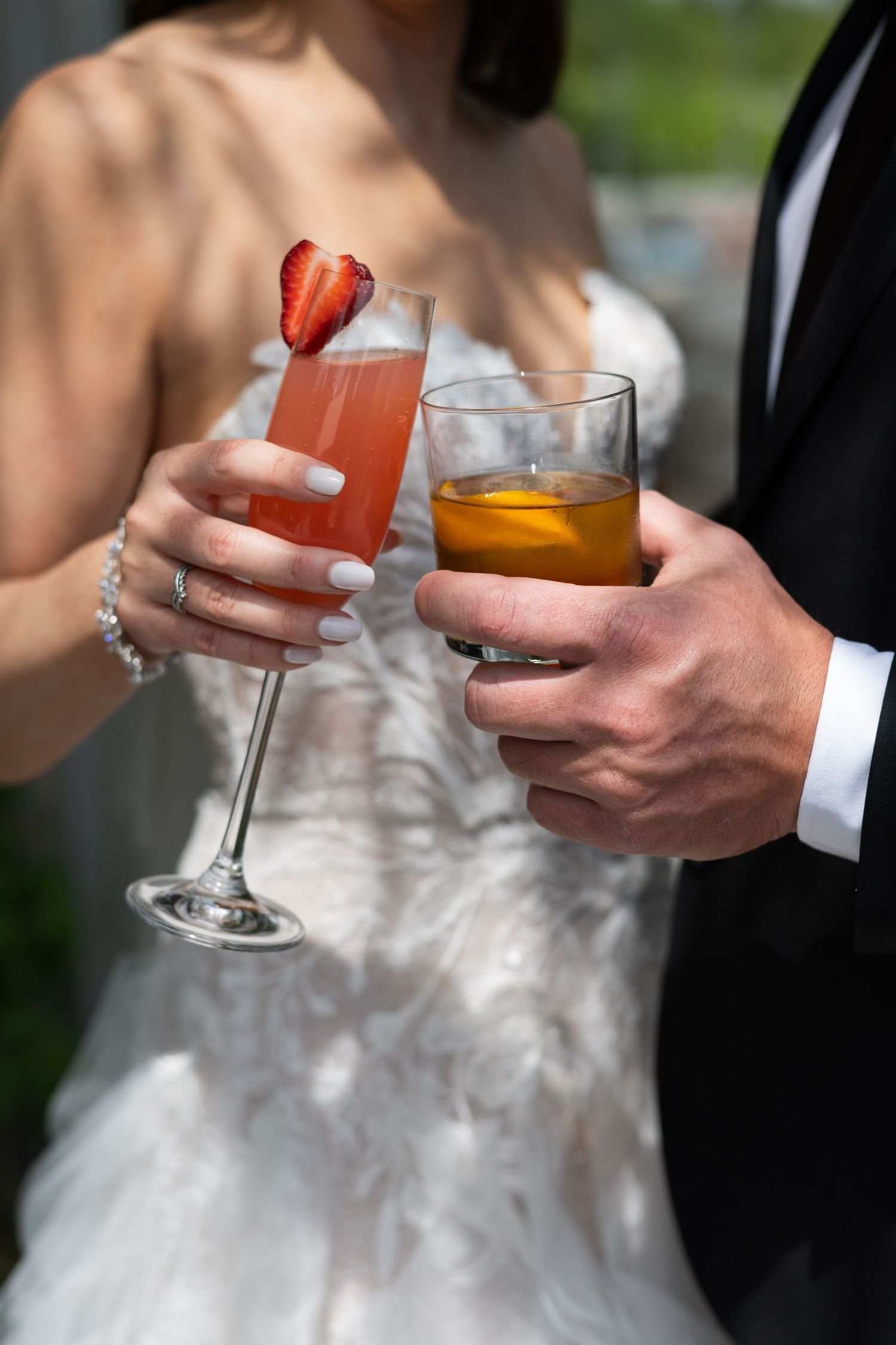 Wedding toast with strawberry cocktail and whiskey drinks.