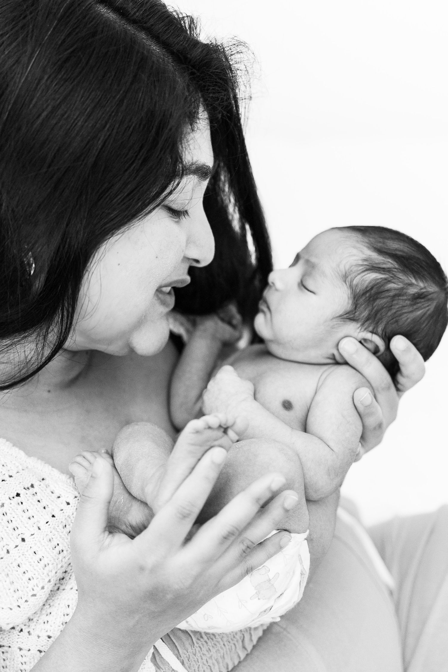 Black and white portrait of intimate mother and baby moment.