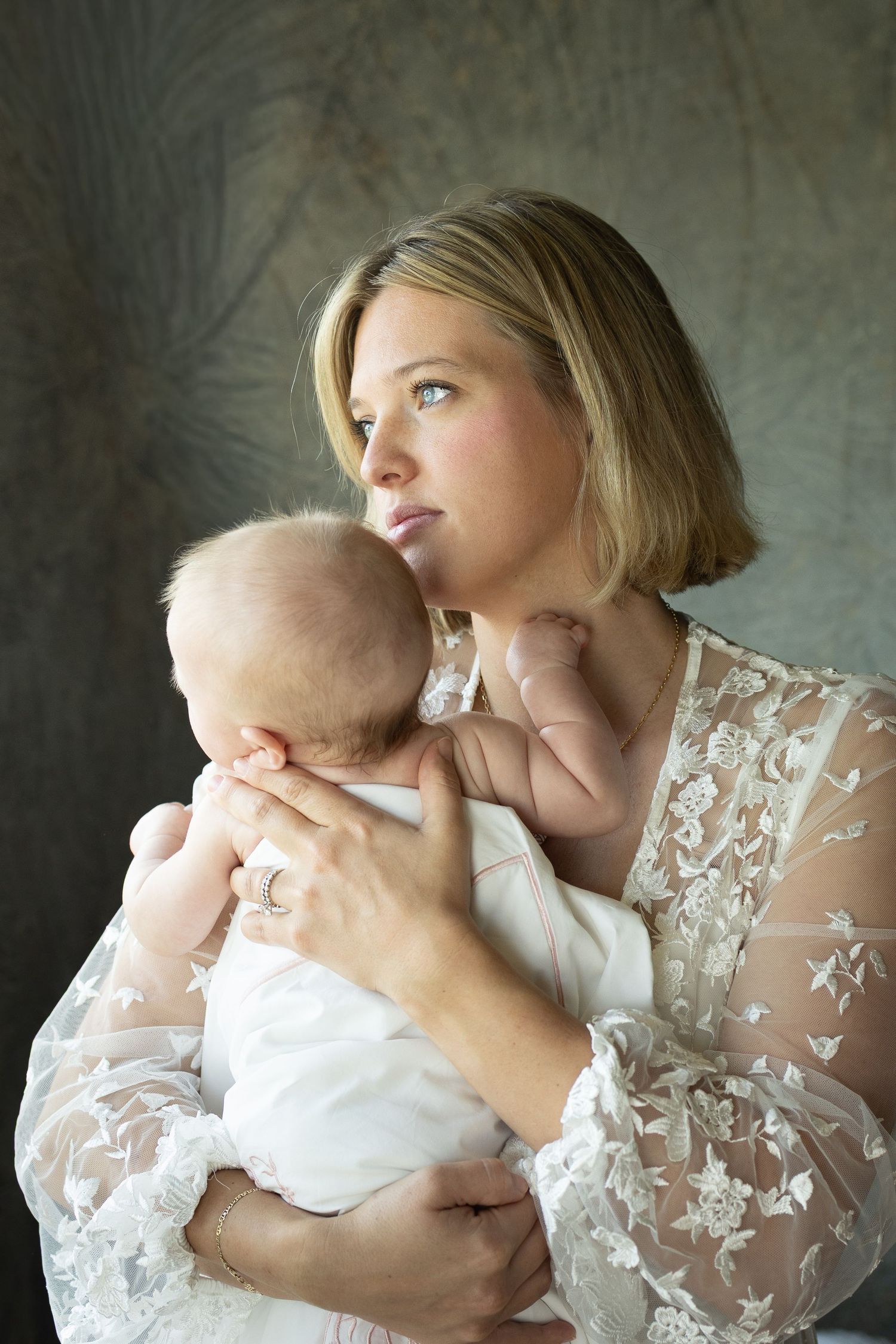 Emotional mother-child portraits featuring delicate lace overlay against neutral background.